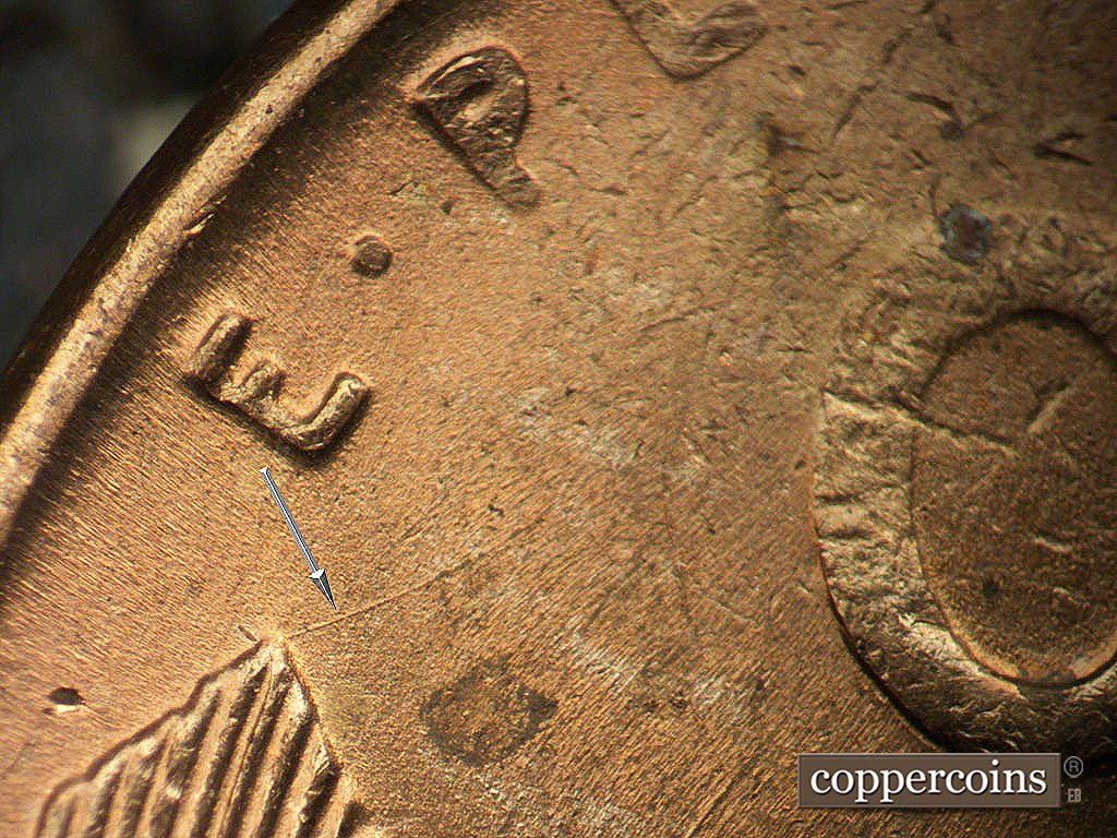 Die-stage B marker on 1945P•1DO•024 showing NE die scratch from left wheat tip.