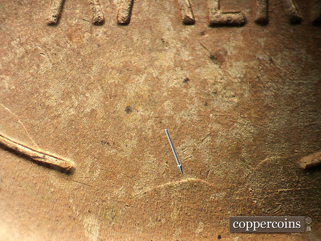 Die-stage B marker on 1945P•1DO•024 showing Die clash between wheat stem tips.