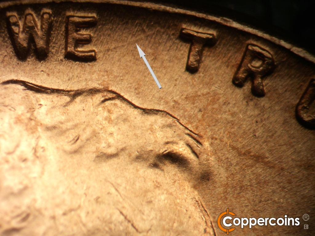 Die-stage B marker on 1945P•1DO•025 showing Curved die gouge from E in WE.