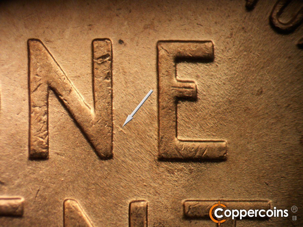 Die-stage B marker on 1945P•1DO•025 showing SE die scratch from N in ONE.