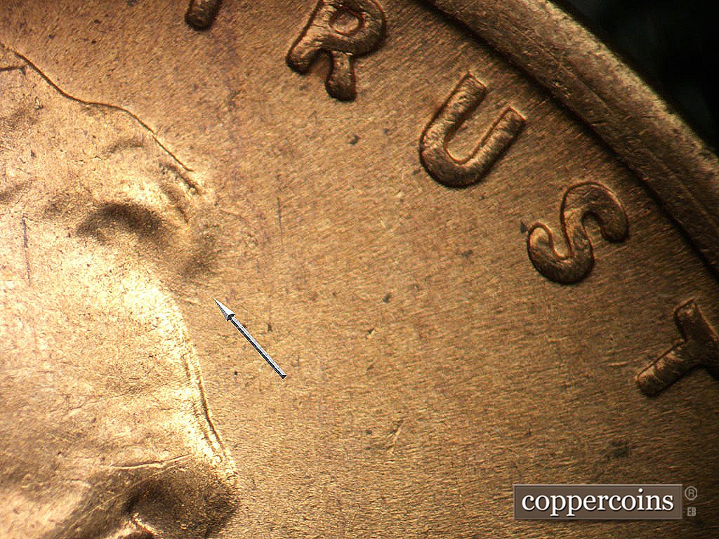 Die-stage B marker on 1945S•1MM•031 showing Short SE die scratches from forehead.