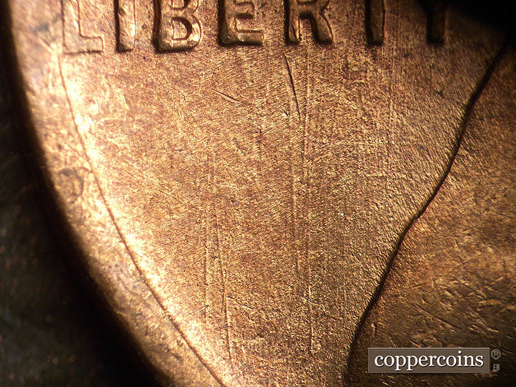 Die-stage B marker on 1945S•1MM•033 showing Generally N/S die scratches under LIBERTY.