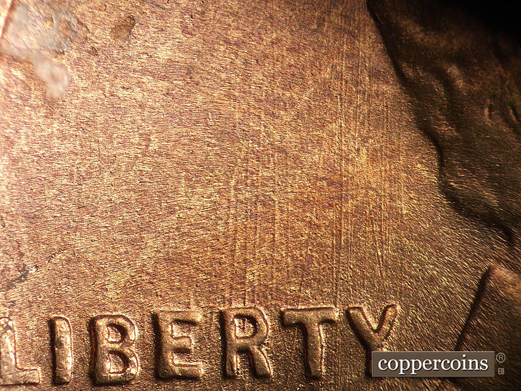 Die-stage B marker on 1945S•1MM•033 showing N/S die scratches above LIBERTY.