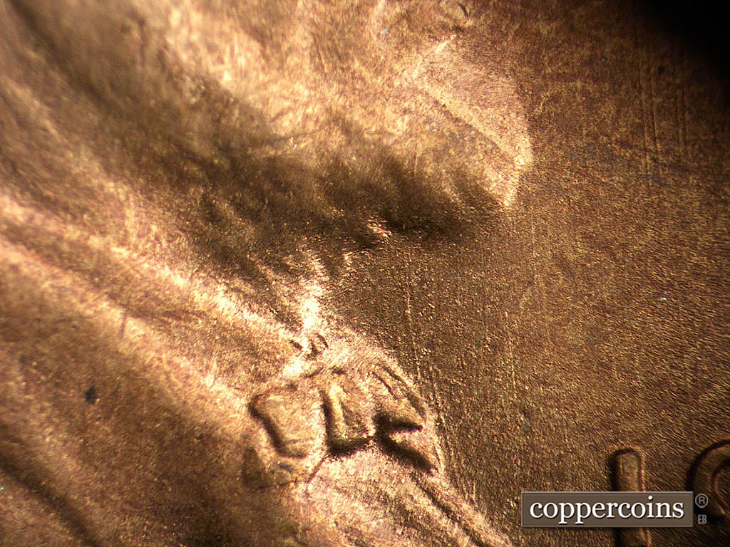 Die-stage B marker on 1945S•1MM•033 showing Die scratches from top of bowtie.