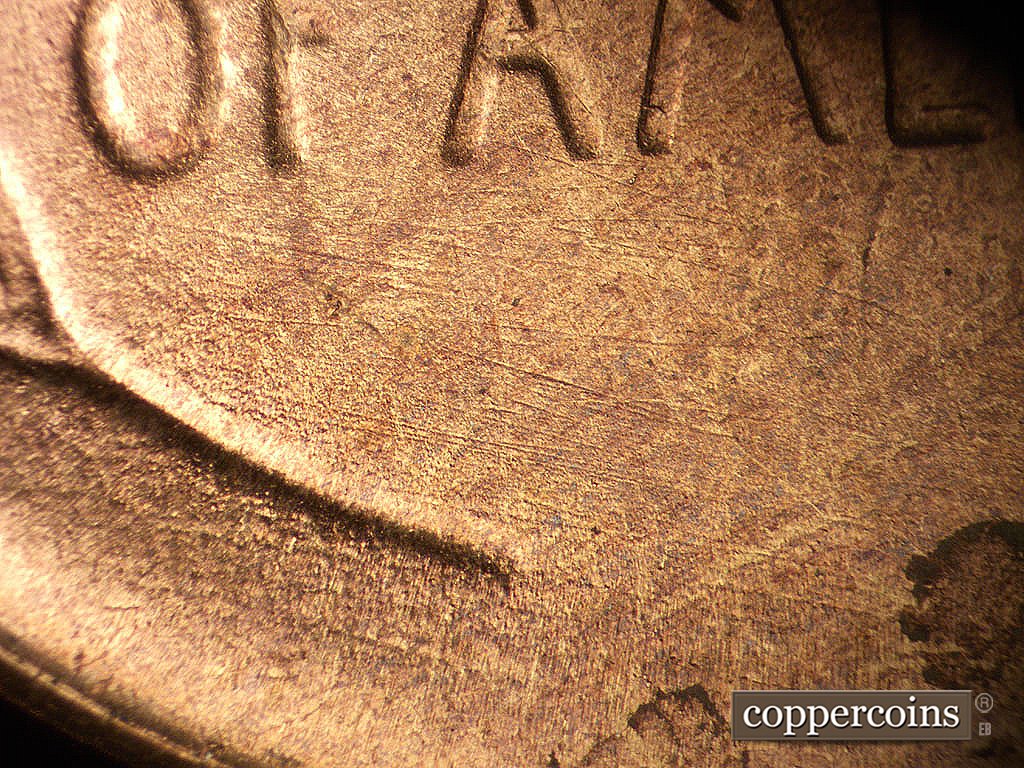 Die-stage B marker on 1945S•1MM•033 showing ESE die scratches below OF and AMERICA.
