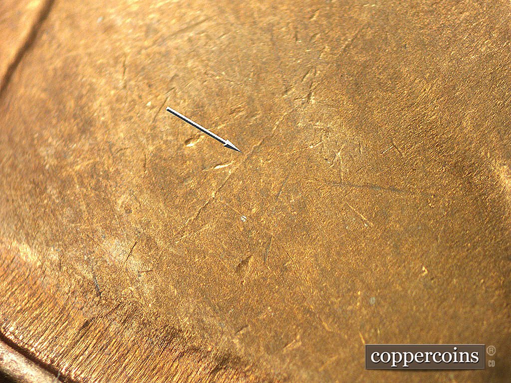 Die-stage C marker on 1946D•1MM•017 showing NE die crack on shoulder.