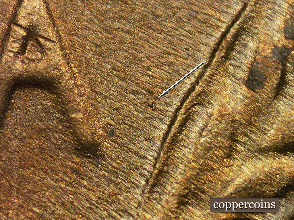 Die-stage C marker on 1946D•1MM•017 showing Small die gouge (dot) between last A in AMERICA and right wheat stalk.
