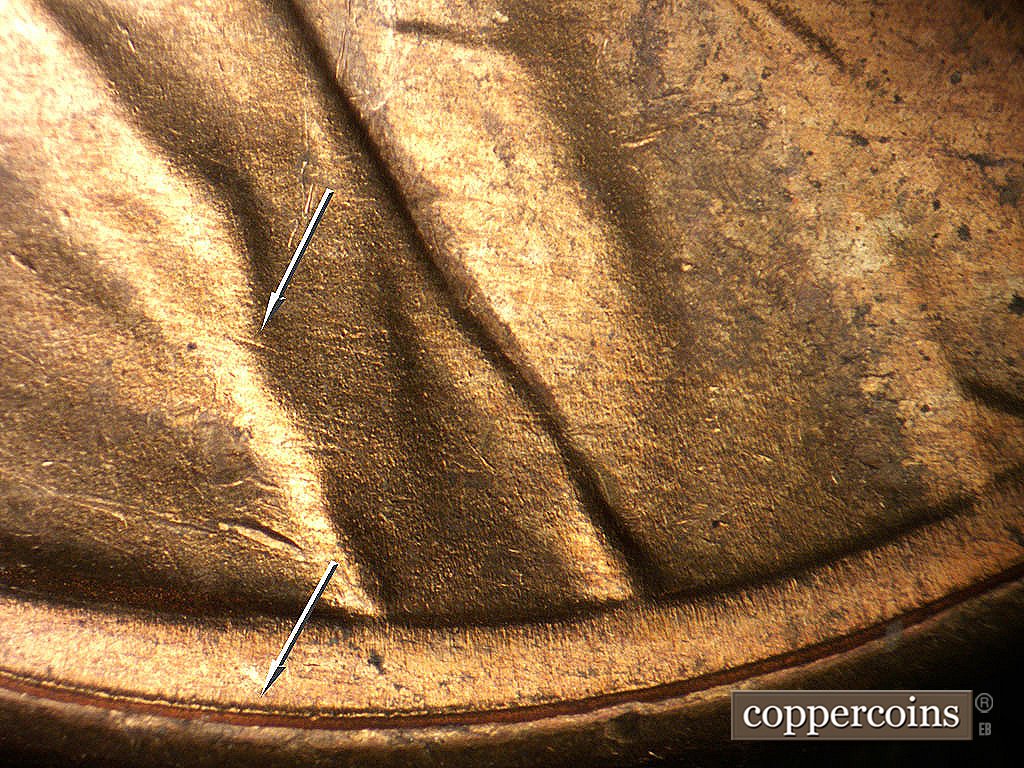 Die-stage B marker on 1946D•1MM•020 showing Die scratch in shoulder fold, Concentric die scratch near rim.