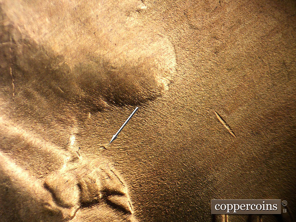 Die-stage B marker on 1946D•1MM•072 showing Die gouge just above bowtie.