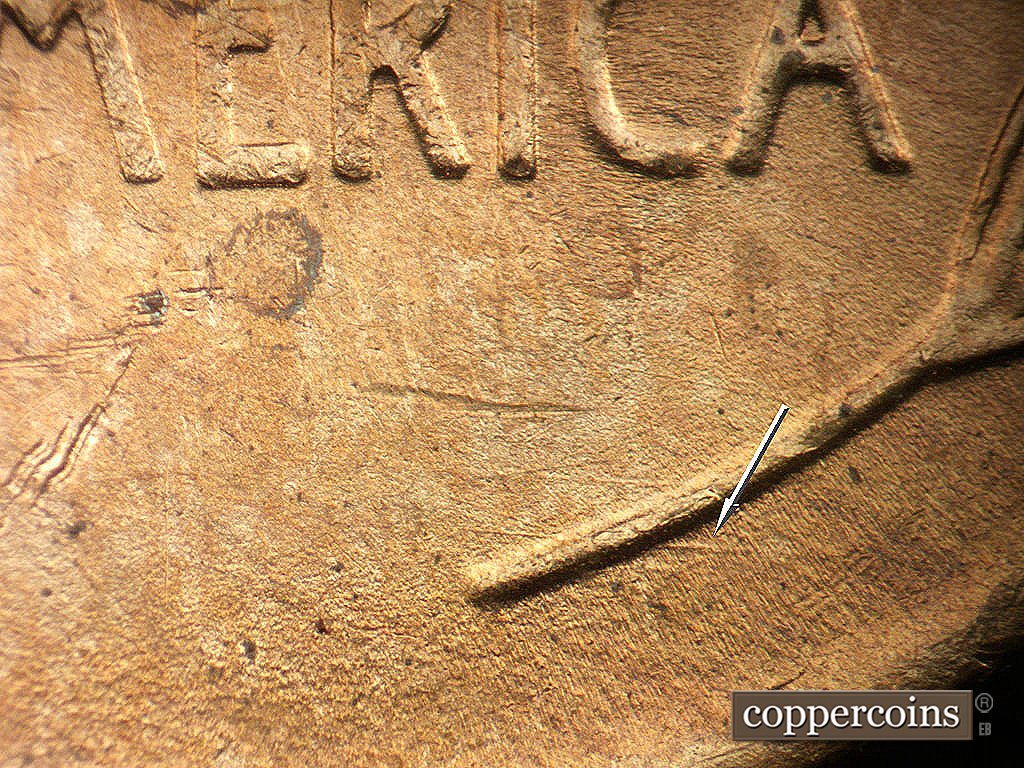 Die-stage B marker on 1946D•1MM•072 showing E/W die scratch from right wheat stem.