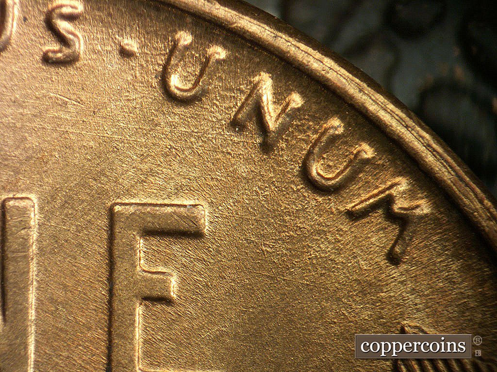 Die-stage B marker on 1946D•1MM•079 showing ESE die scratches through UNUM.