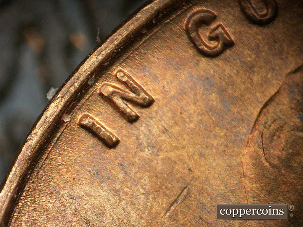 Die-stage A marker on 1946S•1MM•076 showing Concentric die gouge between rim and IN GOD.