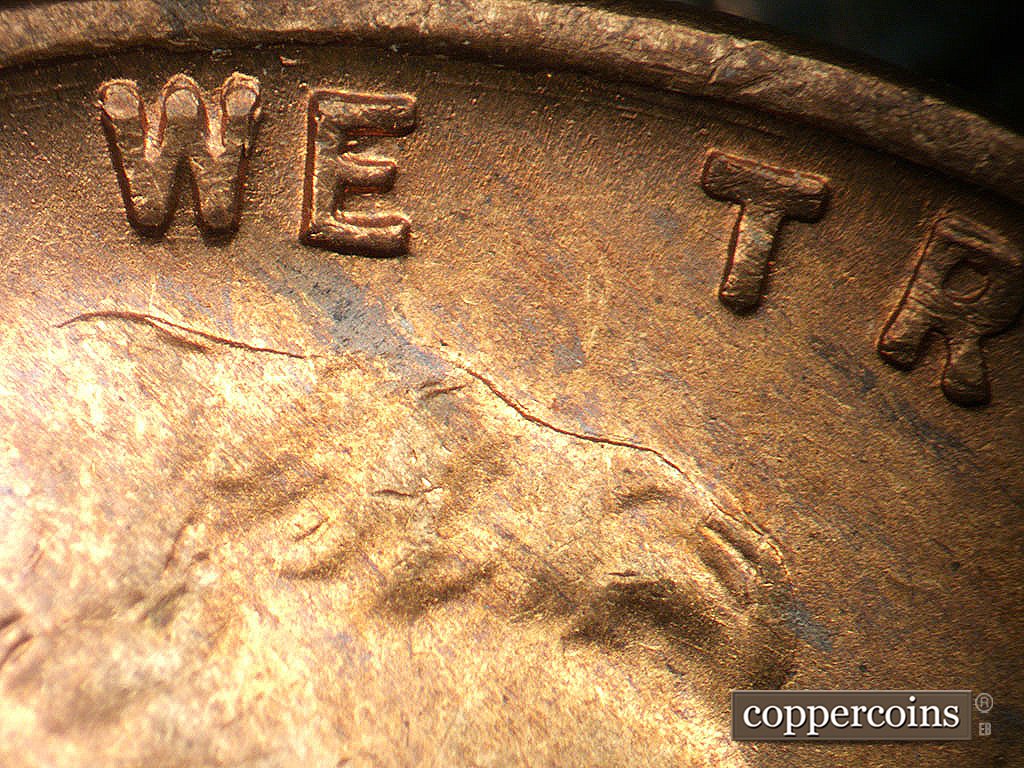 Die-stage A marker on 1946S•1MM•076 showing Concentric gouges btween rim and area between WE and TRUST.
