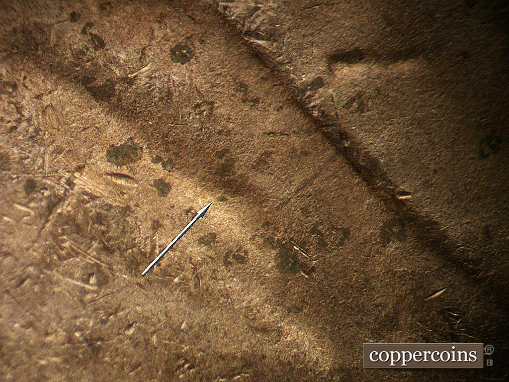 Die-stage B marker on 1948D•1MM•012 showing Die dot in shoulder fold.