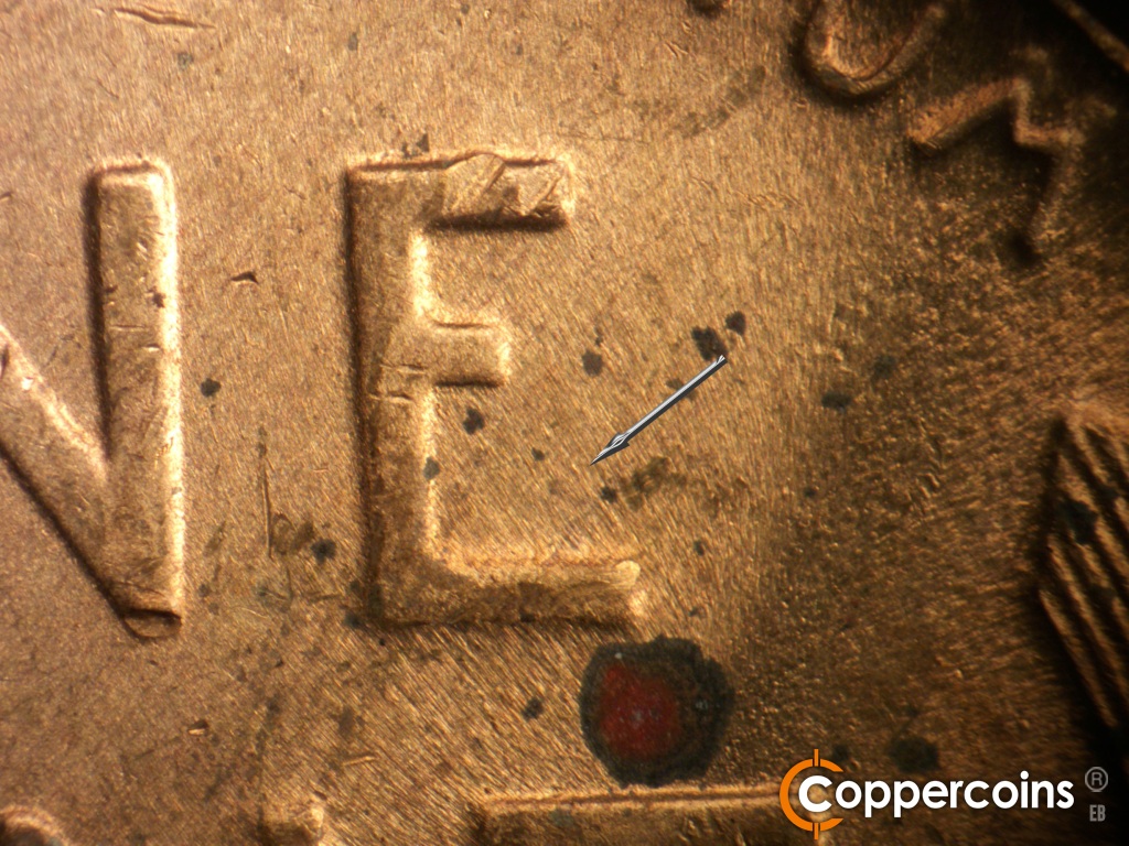 Die-stage C marker on 1948D•1MM•030 showing NW die scratch or flow mark from bottom of E in ONE.