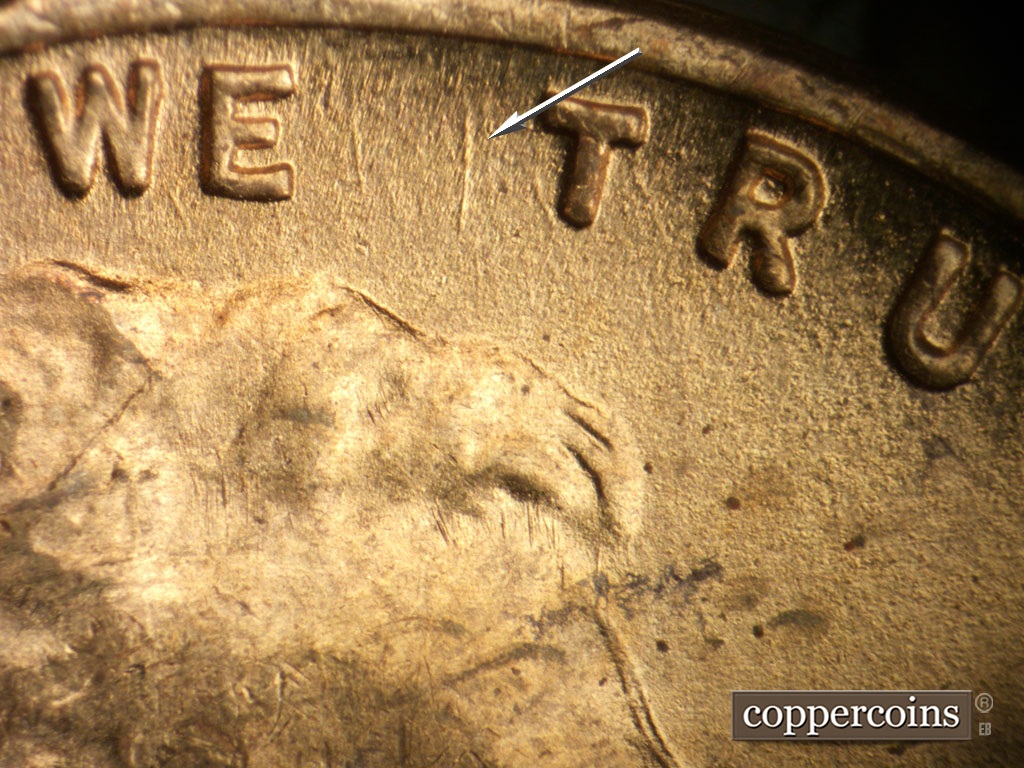 Die-stage B marker on 1948S•1MM•011 showing Heavy N/S die gouge is visible west of first T in TRUST.