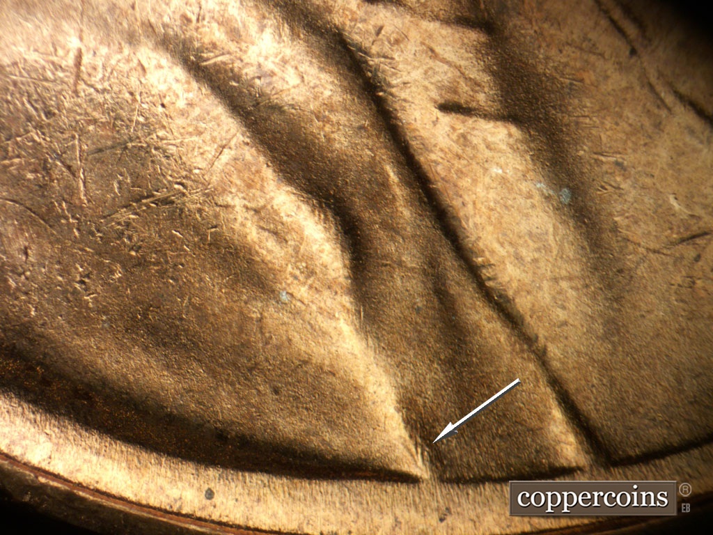 Die-stage B marker on 1948S•1MM•018 showing Short N/S die goiuge in shoulder fold.