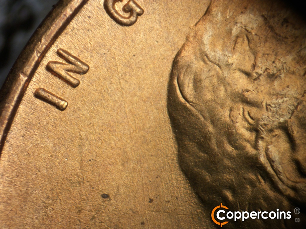 Die-stage B marker on 1948S•1MM•019 showing NNW die scratch behind head.