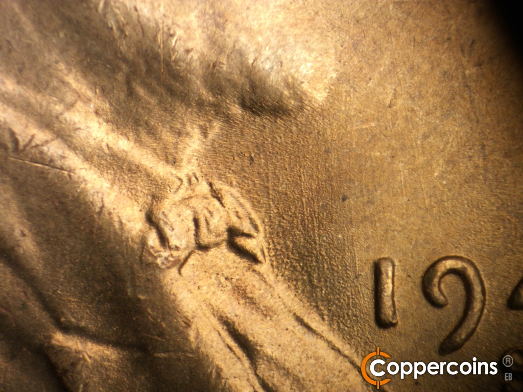 Die-stage B marker on 1948S•1MM•019 showing Generally N/S die scratches in front of bowtie.