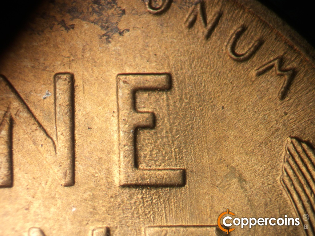 Die-stage B marker on 1948S•1MM•019 showing Worn die scratches in E of ONE.