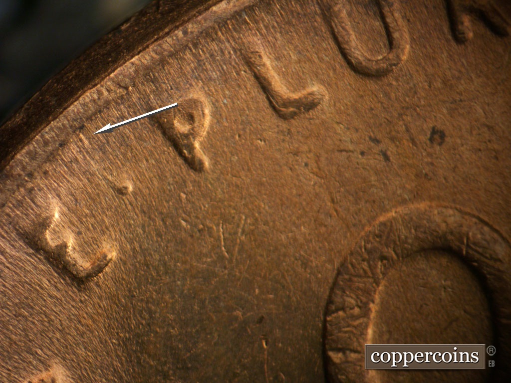 Die-stage B marker on 1949D•1MM•037 showing Small die chip above the dot between the E and P of E PLURIBUS.