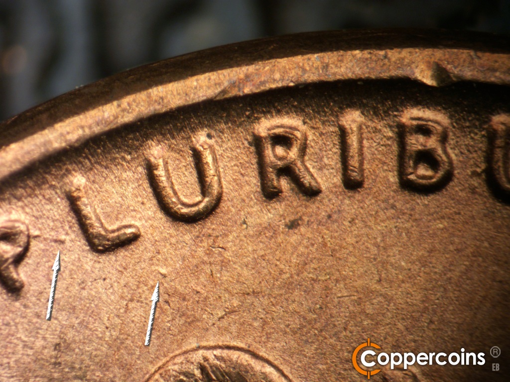 Die-stage B marker on 1949D•1MM•039 showing Doubling seen on URIB in PLURIBUS> Die gouge from P in PLURIBUS. Small die gouge under LU in PLURIBUS.