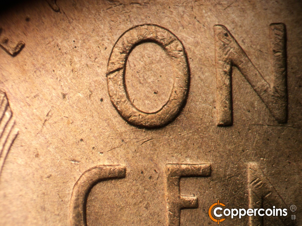 Die-stage B marker on 1949D•1MM•040 showing Light SSW die scratches between ON in ONE.