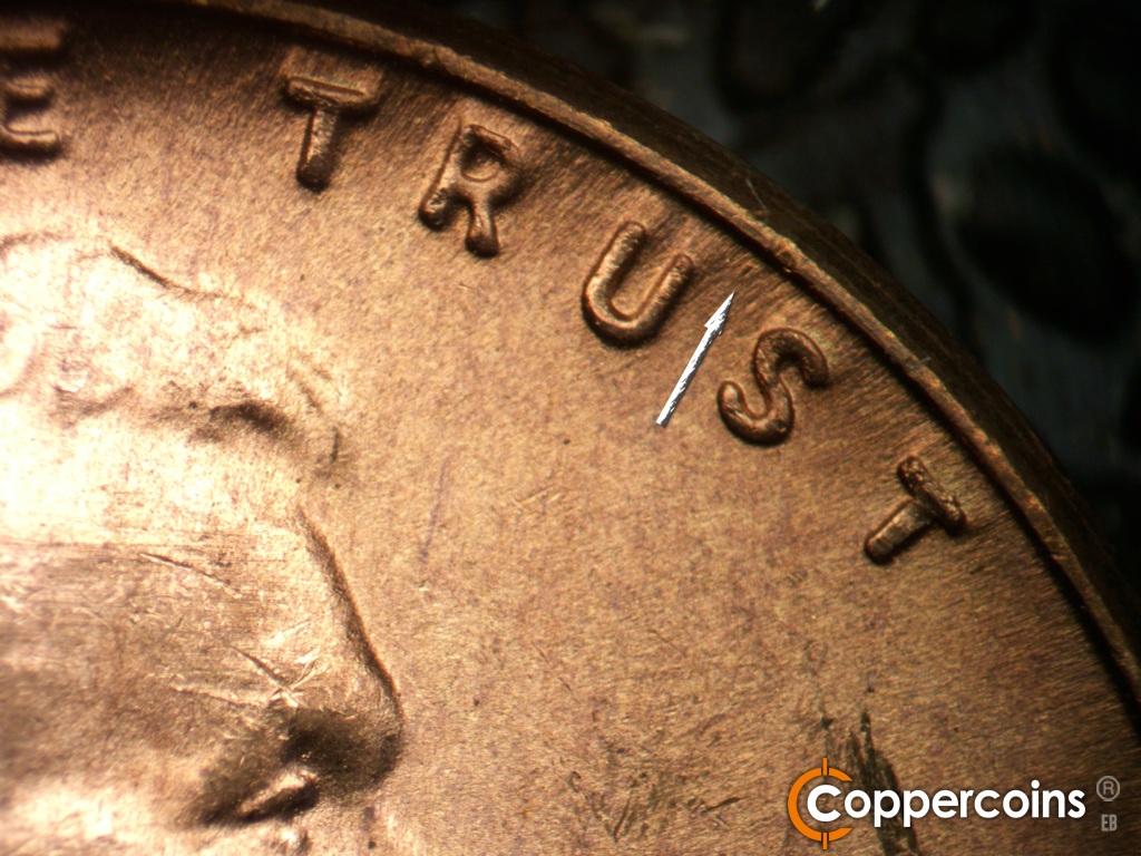 Die-stage C marker on 1949D•1MM•042 showing Worn die mark near rim between US in TRUST.