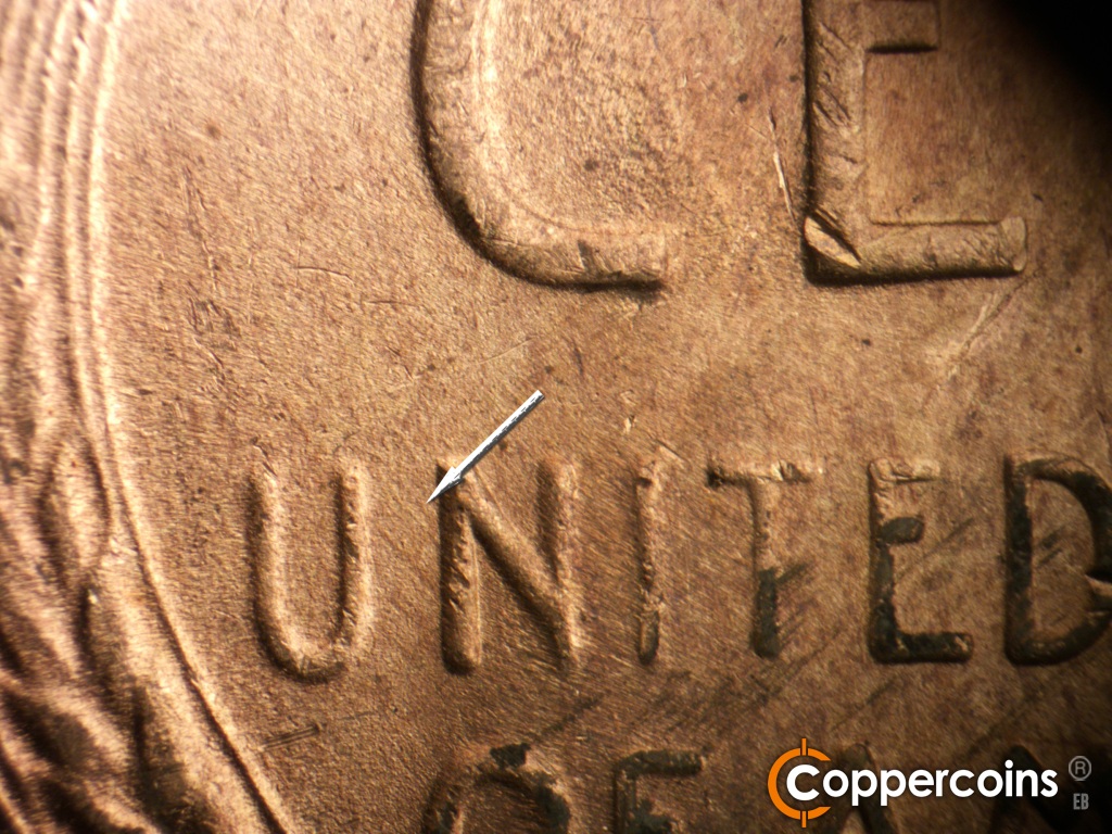 Die-stage C marker on 1949D•1MM•042 showing NW die scratch from N in UNITED.