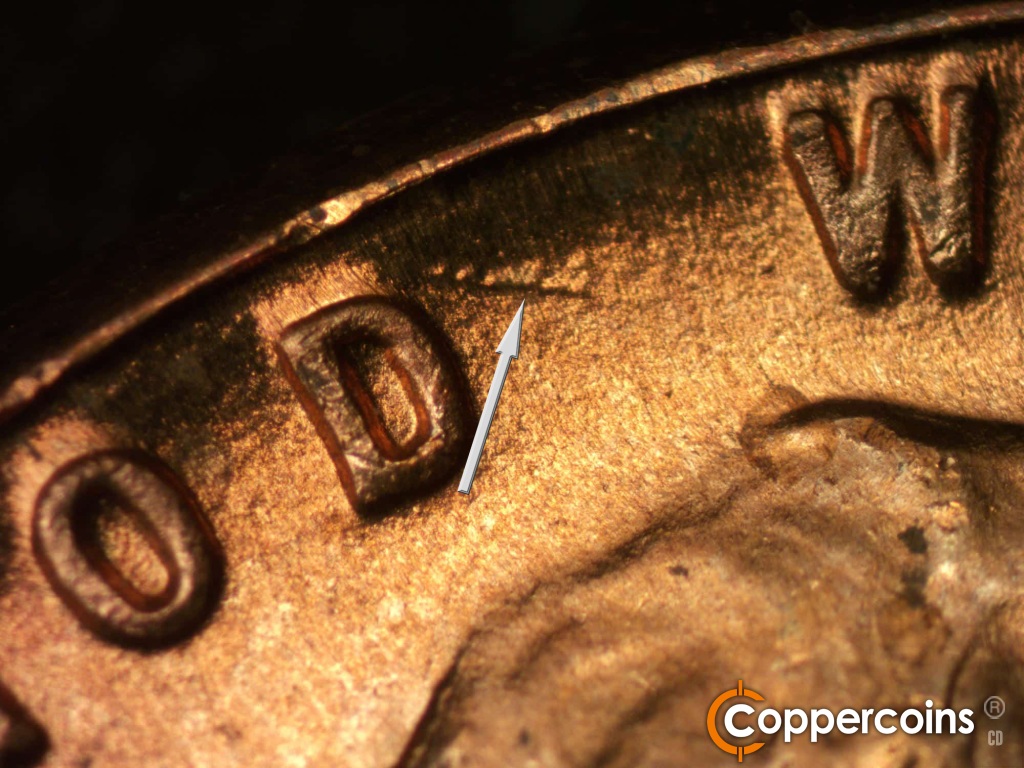 Die-stage B marker on 1950D•1DO•004 showing ESE die gouge from top of D in GOD.