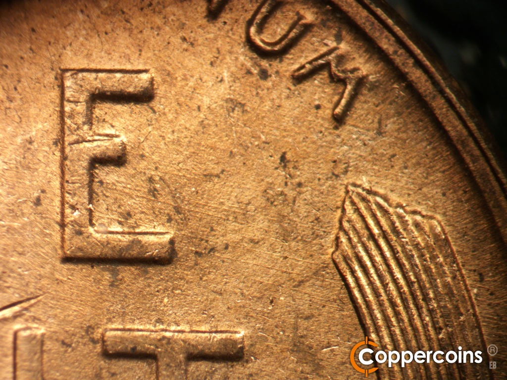 Die-stage B marker on 1950D•1DO•005 showing ESE die scratches from E in ONE.