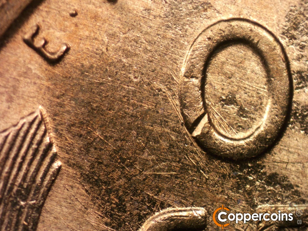 Die-stage A marker on 1950D•1MM•011 showing Die scratches cover upper left of reverse.