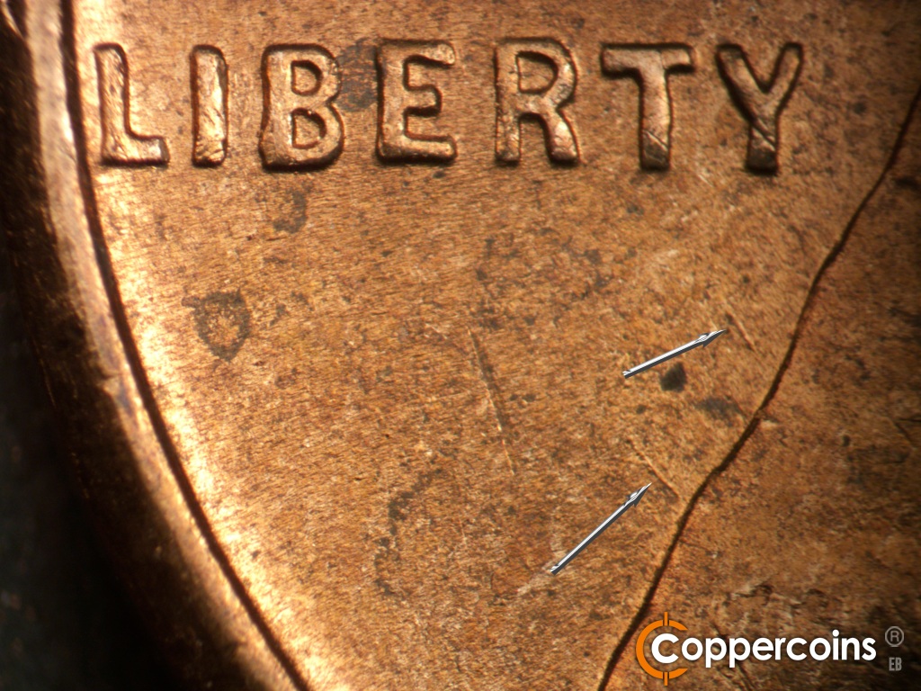 Die-stage B marker on 1950D•1MM•038 showing NW die scratches from back of jacket.