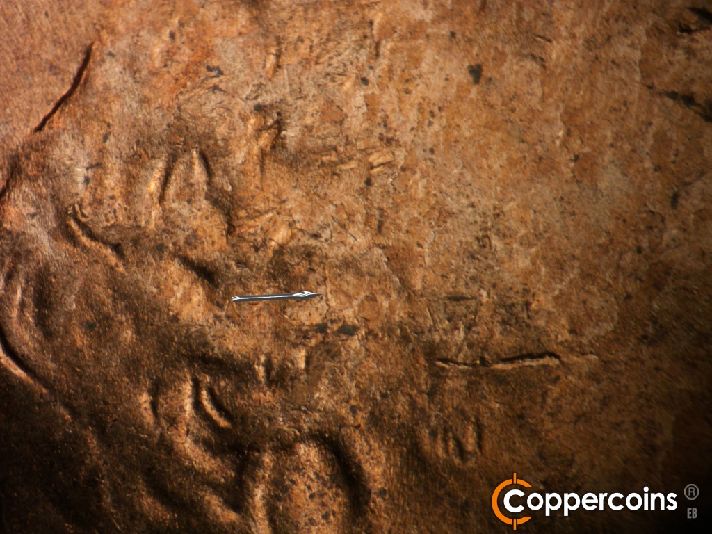 Die-stage B marker on 1950D•1MM•038 showing Die crack in hair.