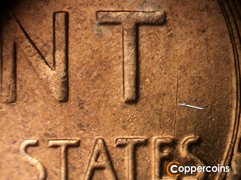 Die-stage B marker on 1950D•1MM•038 showing N/S die scratch from E in STATES.