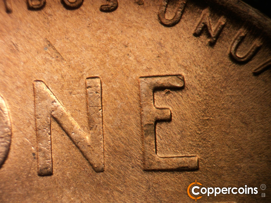 Die-stage B marker on 1950D•1MM•039 showing Die chip in upper E of ONE.