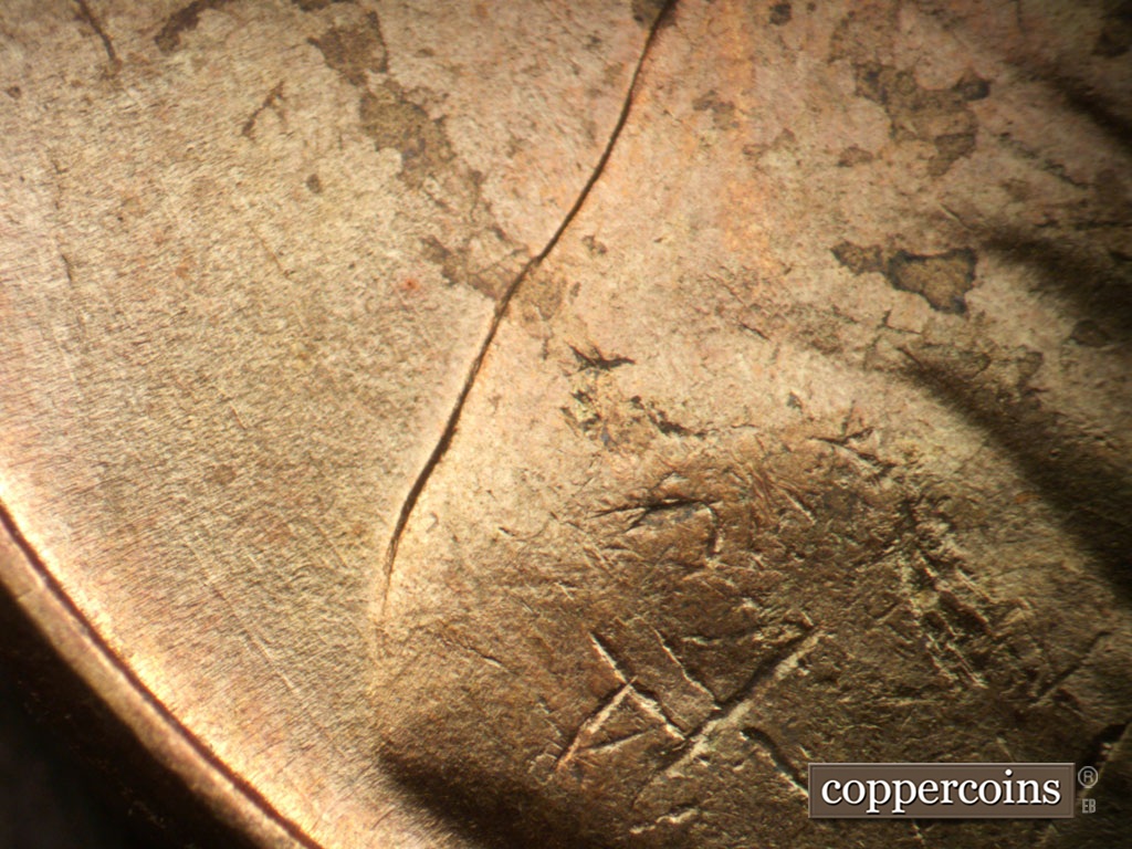 Die-stage A marker on 1950P•1DO•005 showing Concentric die scratches from back of shoulder.