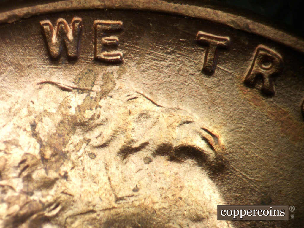 Die-stage A marker on 1950P•1DO•005 showing Concentric die scratches through WE TRUST.