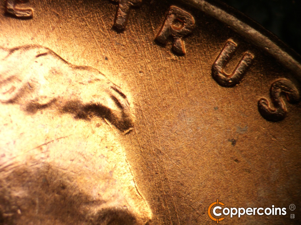Die-stage A marker on 1951D•1MM•006 showing SSE die scratches in front of forehead.