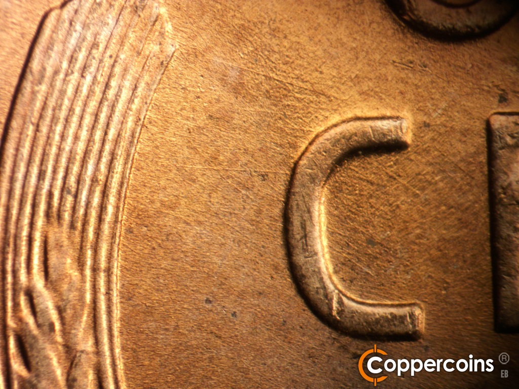 Die-stage A marker on 1951D•1MM•006 showing E/W die scratches between left wheat stalk and C in CENT.
