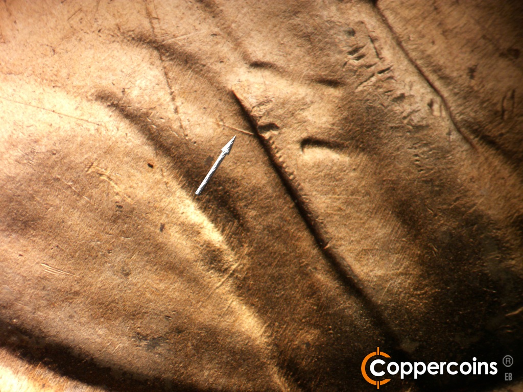 Die-stage B marker on 1951D•1MM•072 showing WNW die scratch from lapel.