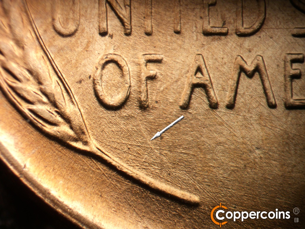 Die-stage B marker on 1951D•1MM•072 showing Multidirectional die scratches cover lower left of reverse. Die clash show above left wheat stem.