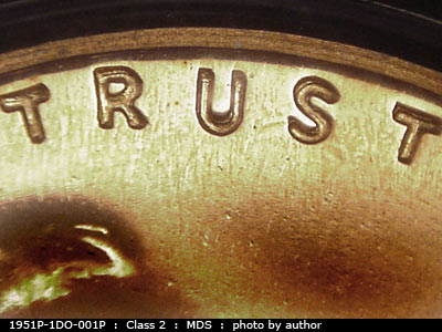 Die-stage B marker on 1951P•1DO•001P showing Strong doubling shows in the area of trust toward the rim.