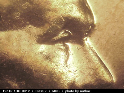 Die-stage B marker on 1951P•1DO•001P showing The entire length of the eyelid shows doubling.