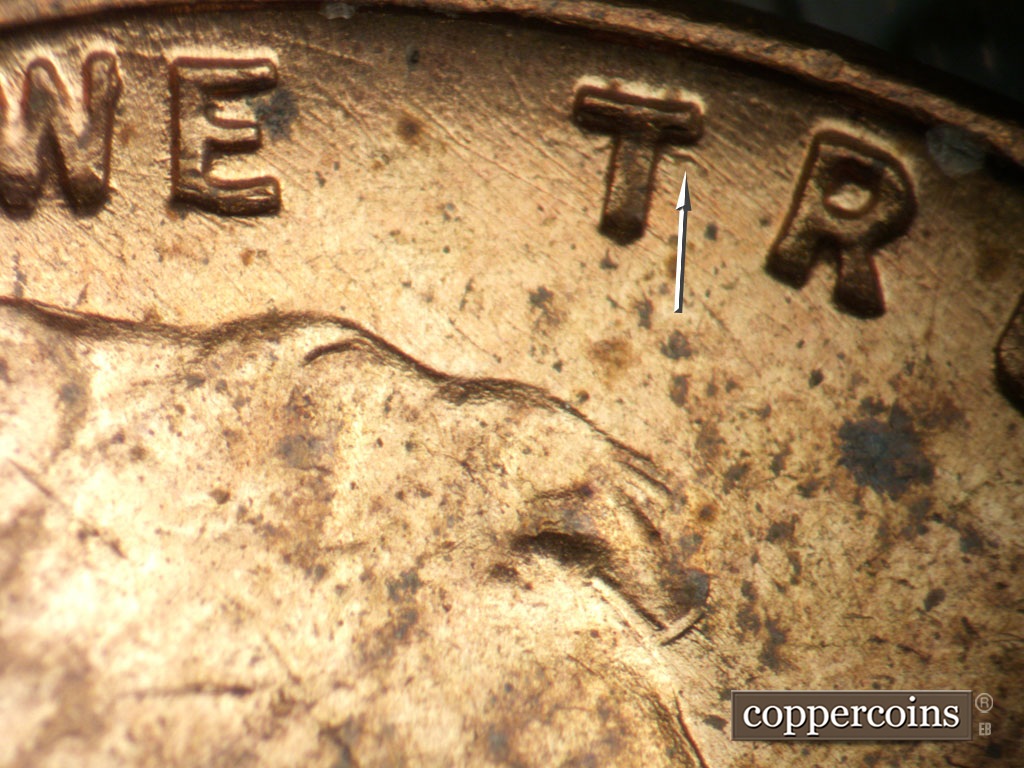 Die-stage A marker on 1951P•1DO•003 showing Die scratches through WE TRUST. Unique die gouge near top of first T in TRUST.