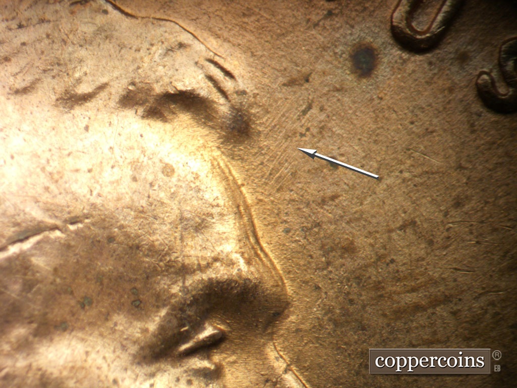 Die-stage B marker on 1952D•1DO•010 showing Very light generally NE die scratching in front of har.