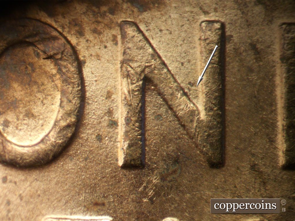 Die-stage B marker on 1952D•1DO•010 showing ESE die scratch in N of ONE.