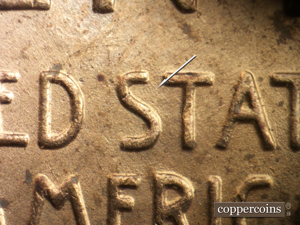 Die-stage B marker on 1952D•1DO•010 showing SE die scratch from the top of the first S in STATES.