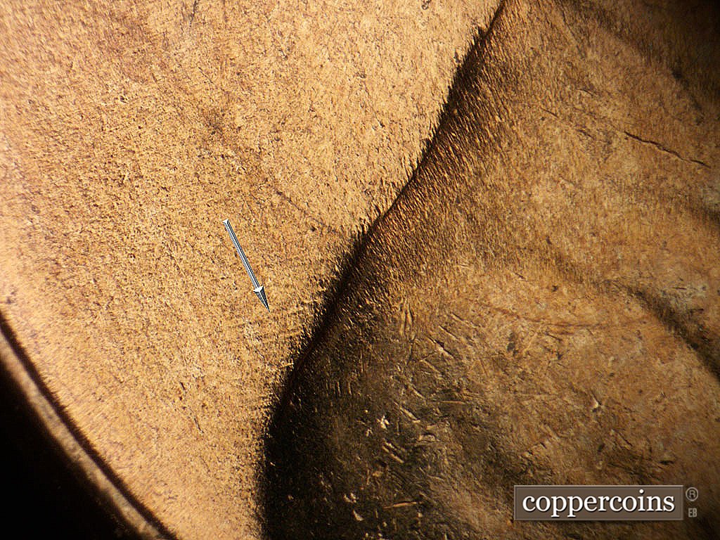 Die-stage A marker on 1952D•1MM•002 showing WSW die scratches from lower shoulder.