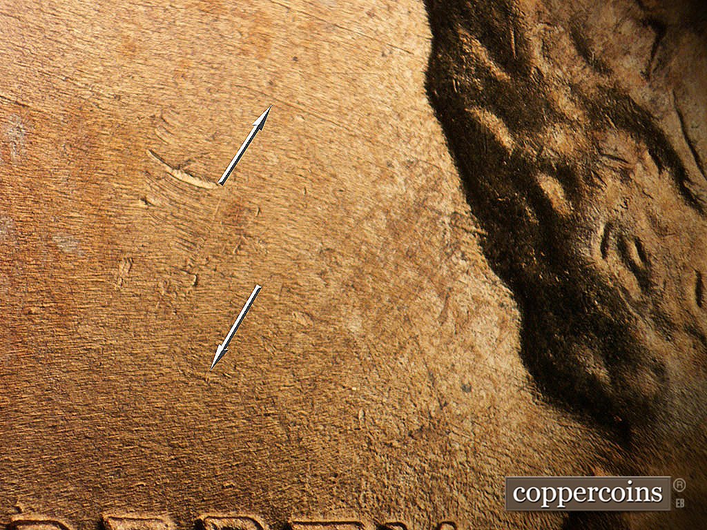 Die-stage A marker on 1952D•1MM•002 showing NW die scratches from back of head.